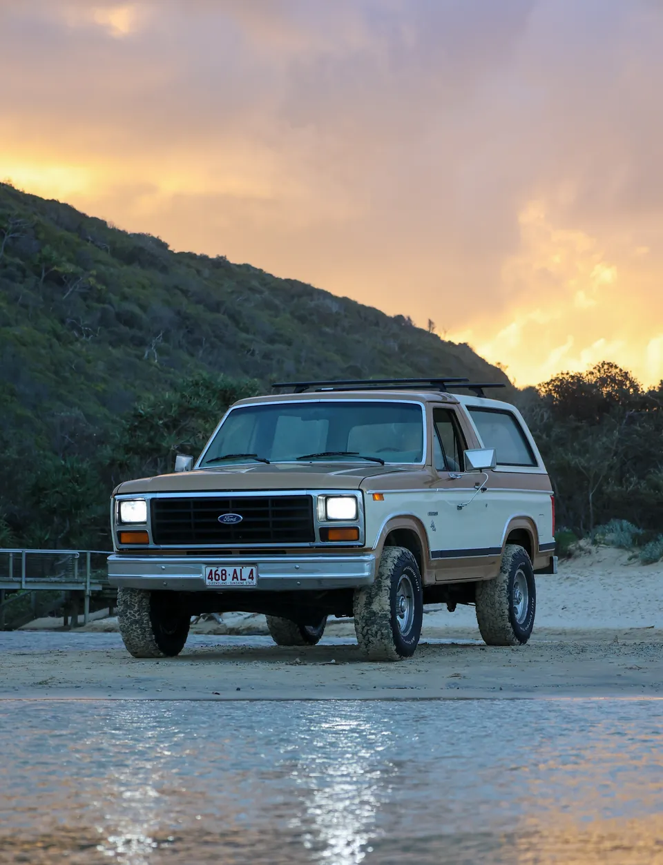 Classic Ford Bronco photographed on a Queensland beach at sunset