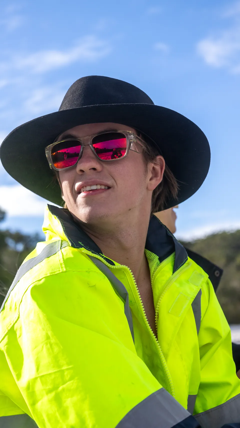 Portrait of a person in high-visibility clothing photographed outdoors