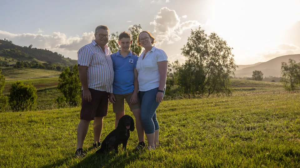 Family photographed in a paddock at golden hour