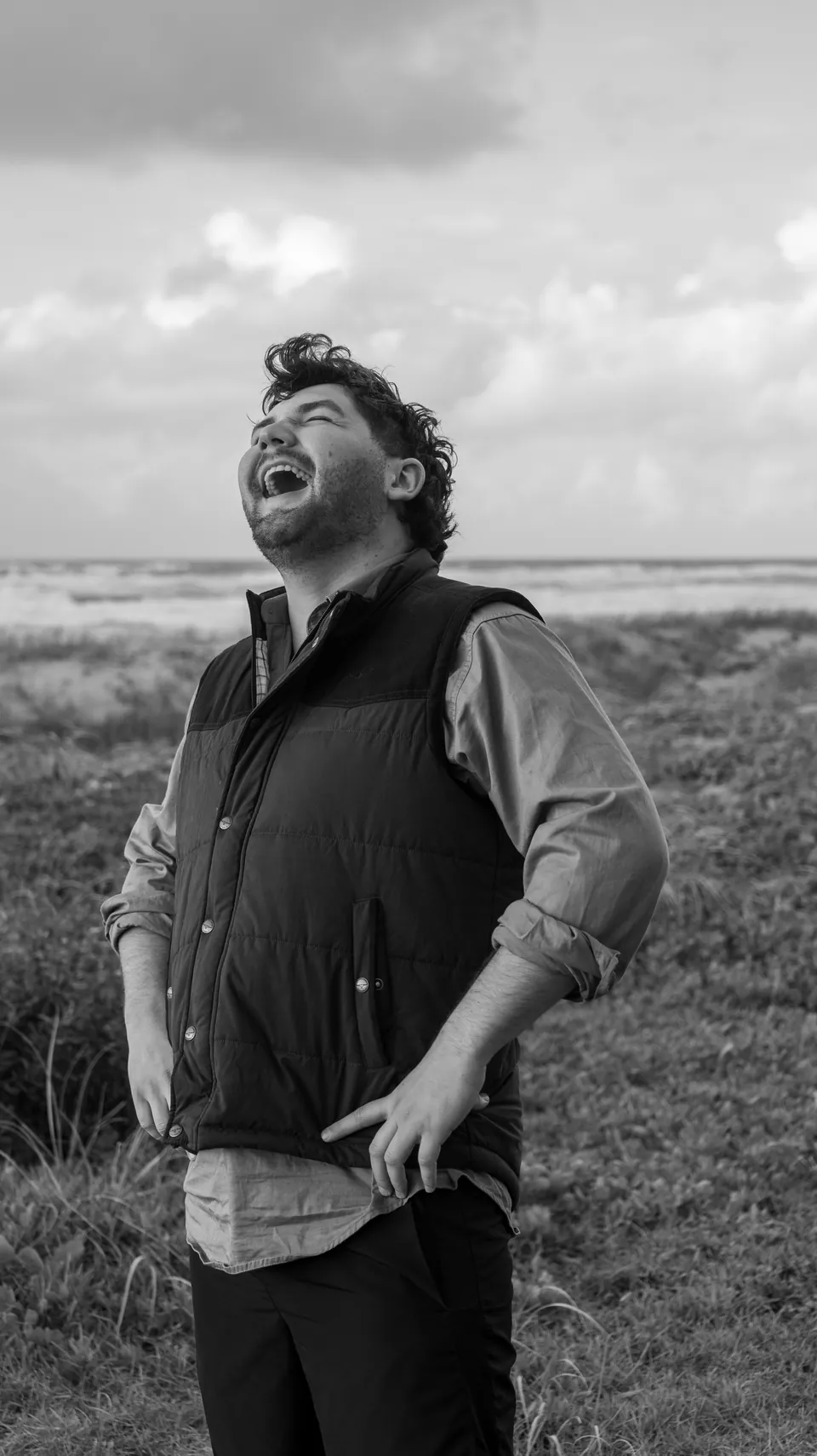 Black and white candid portrait of a man laughing