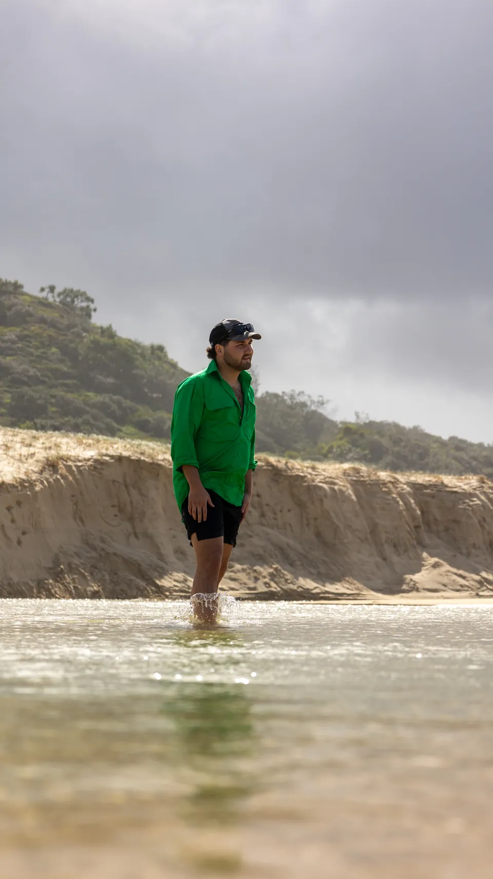 Man walking along the shoreline at low tide