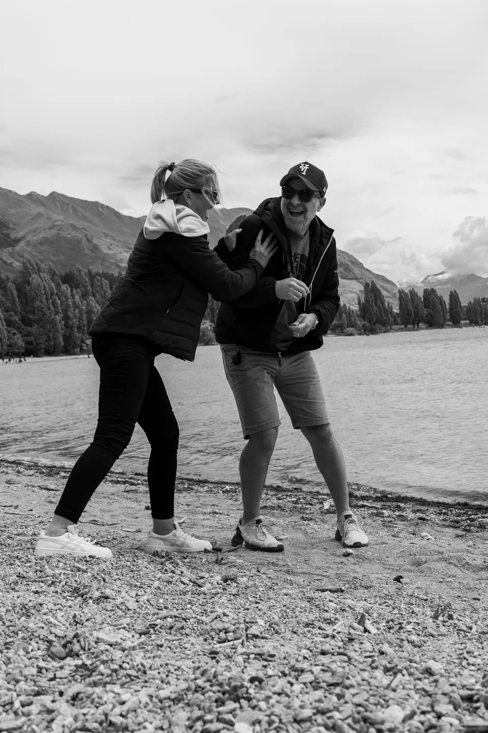 Black and white portrait of two people by the water