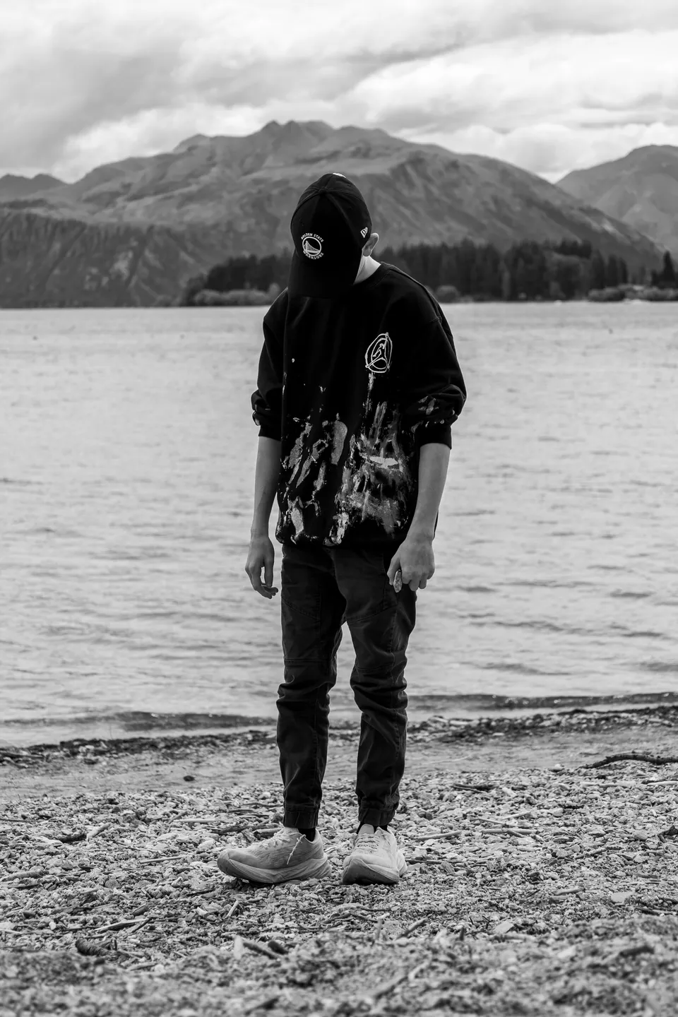 Black and white photograph of a person at the water's edge